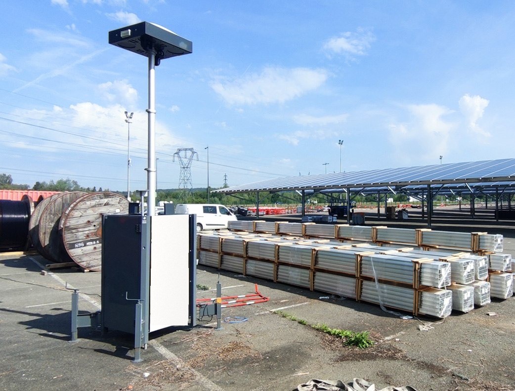 OMNIGARD tower watching over a logistics yard lined with a photovoltaic canopy